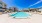 Large sparkling blue pool with a large pool deck and lounge chairs